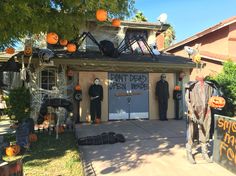 a house decorated for halloween with pumpkins and decorations