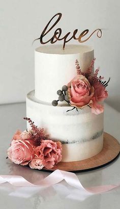 a white cake with pink flowers on top