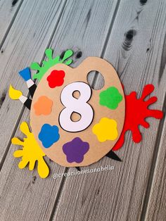 the number eight painted on top of a wooden board