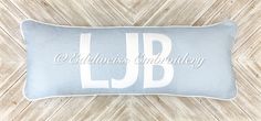 a blue and white pillow with the word lub on it in cursive font