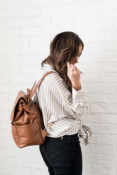 Say hello to the Milan-- a premium vegan leather backpack with trolley sleeve. The Milan is the perfect for modern playdates (best diaper bag), weekends away and everything in between. There are 8 pockets on the inside and and 4 on the outside. The Milan is unlike any other bag on the market as the interior can be completely removed and washed. The flap closure features strong interior magnets for an easy and strong one handed close. Best Diaper Bag, Vegan Leather Backpack, Leather Wear, Diaper Bag Backpack, Easy Travel, Backpack Travel Bag, Black Friday Shopping, Lifestyle Brands, Pebbled Leather