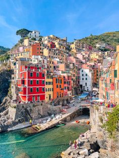 boats are parked on the water in front of colorful buildings