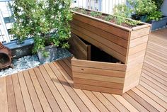 a wooden deck with planters and potted plants