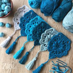 crocheted doily and balls of yarn laid out on a wooden table top