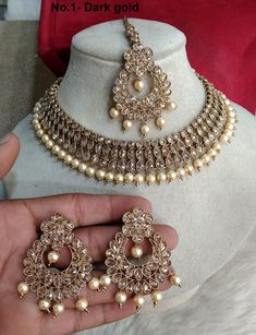 * Light weight antique gold necklace set studded with crystals. *Necklace Width- 1.1 inches ( Included drops) *Earrings Length- 2 inches *Earrings Breadth- 1.4 inches Gold Chandbali-shaped Jeweled Bridal Necklace, Gold Chandbali Bridal Necklace Jeweled, Gold Chandbali Bridal Necklace With Jeweled Details, Gold Costume Jewelry Bridal Necklace With Jewels, Gold Jeweled Costume Jewelry Bridal Necklace, Gold Kundan Jeweled Necklaces, Gold Chandbali Jewelry With Jewels, Gold Kundan Necklace With Jewels, Gold Bollywood Necklaces With Jewels