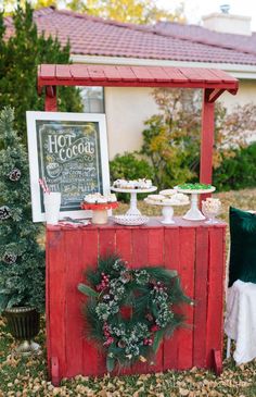 an outdoor dessert bar with christmas wreaths on it