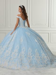 Receive lots of compliments in this long cold shoulder dress with A-line skirt by House of Wu Quinceanera Collection 26980. Made out of tulle, this beautiful off shoulder ball gown features a sweetheart bodice adorned with glitter floral appliques, cap sleeves, and gathering tulle with large glitter floral hem edge with layers of tulle A-line skirt. This look is finished with a lace-up corset back and a sweep train. House of Wu Quinceanera Collection Fall 2021 Style Number: 26980 Fabric: Tulle/G Applique Jumpsuit, Quinceanera Collection, Off Shoulder Ball Gown, Debutante Ball, Trumpet Dress, Sheath Gown, Quinceanera Dress, Sequin Appliques, Couture Candy