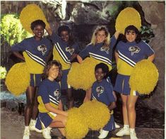 a group of cheerleaders posing for a photo in blue and yellow outfits with pom - poms