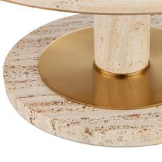 a close up of a marble and brass table with a round base on it's side