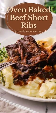 a white plate topped with mashed potatoes covered in beef short ribs and gravy