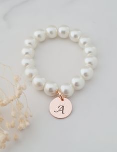 This sweet little pearl bracelet is personalised pearl to suit your bridal party. This bridal bracelet is made from 8mm glass pearls and 12mm rose gold plated initial disc. Your jewellery will arrive in a gift box ready for giving. This item ships from the UK within 1 working day. Please see size guide below: Sizes for children 3-6 months    4.25-4.5in 6-12 months    4.75in 12-24 months    5in 2-3 years    5.0-5.5in 4-5 years    5.75in 6-8 years    6in 9-13 years    6.25in Adult Sizes Small                  6.5in Medium             7in Large                  7.5in Personalized Elegant Pearl Bracelet, Elegant Personalized Round Bead Pearl Bracelet, Personalized Round Bead Pearl Bracelet, Personalized Round Bead Pearl Bracelet In Elegant Style, Elegant Personalized Pearl Bracelet, Elegant Pearl Bracelet With Letter Beads, Elegant Personalized Rose Gold Beaded Bracelets, Elegant Personalized Rose Gold Beaded Bracelet, Pearl Beaded Bracelets With Pearl Charm For Bridesmaids