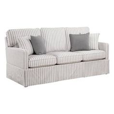 a white and grey striped couch with pillows on it's armrests, against a white background