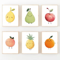 four framed pictures with fruit on them in different shapes and sizes, each featuring an apple, pear, orange, and pineapple