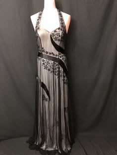 "This beautiful long Black with white lining sleeveless gown is beaded and embroidery design all over in the front and back. This gown has amazing workmanship and looks very elegant. Measurements for this gown are: Size-4                                  Size-6                                                    Chest - 32\"                         Chest-34\"                      Waist - 27\"                          Waist-27\"                        Length - 59\"                       Length-60\ Embellished Full-length Evening Dress, Formal Gown With Sheer Back And Fitted Bodice, Full Length Gown With Sheer Bodice For Evening, Maxi Length Evening Dress With Back Opening, Elegant Formal Evening Dress With Sheer Back, Evening Gown With Lined Bodice, Full Length, Elegant Gown With Sheer Back For Evening, Elegant Lined Maxi Evening Dress, Elegant Maxi Length Lined Evening Dress