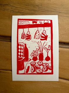 a red and white print on wood with pots