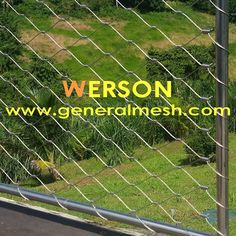 an image of a fence that has the words, person on it and grass in the background