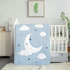 a baby crib with a blue and white blanket on it