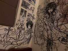 a bathroom with graffiti on the walls and pictures on the wall