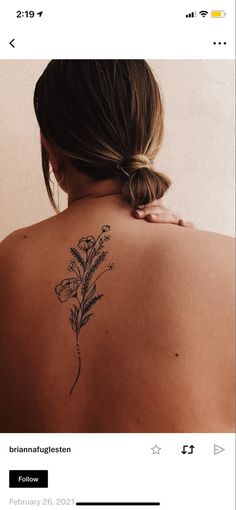 a woman with a flower tattoo on her back