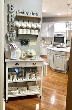 a kitchen with white appliances and wooden flooring in it's center island area