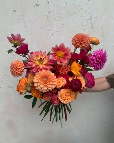 a person holding a large bouquet of flowers