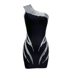 Elevate your style game with our One Shoulder Rhinestone Detail Bandage Mini Dress. Featuring a sleek black design and eye-catching rhinestone detailing, this dress is perfect for any special occasion. The one-shoulder design adds a touch of elegance, while the bandage material flatters your figure for a confident look. Fabric: Medium Stretch Material: Polyester, Spandex Fabric Medium, Shoulder Design, Elevate Your Style, Dress First, Black Design, Mini Black Dress, Polyester Spandex, Special Occasion, One Shoulder