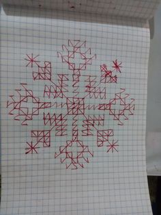 a piece of paper that has been drawn with red ink on it and is sitting on top of a table