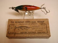 an old fishing lure is hanging on the wall next to a sign that says, the muskegon spoon jack minnow for casting or trolling