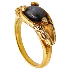 Ancient revival ring with a ram. This is a very unusual and beautiful ring designed in the 19th century with a mix of ancient Etruscan and Egyptian revival patterns. The ring is of European origin and most probably made in England during the middle of the Victorian era, back in the 1860. The ring has been crafted in one solid piece of rich yellow gold of 22 karats with the stylized head of a male-ram with very long horns. The ring is very well executed with nice details of the sculpted ram's hea Hand Forged Symbolic Rings For Collectors, Symbolic Hand Forged Rings For Collectors, Ancient Style Collectible Yellow Gold Rings, Ancient Gold Collectible Rings, Unique Ceremonial Bronze Rings, Stylized Head, Ancient Rings, Long Horns, Grey Sapphire