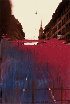 an abstract painting with buildings in the background and red, white and blue paint on it