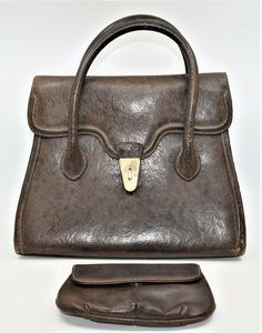 Vintage large Gucci Brown Leather Purse, Hand Bag plus Cosmetics Bag. It has a luxurious amber colored leather interior with numerous compartments: one has a zipper closure, one has a snap and the third hangs freely PLUS there is the large compartment that comprises the majority of the space. As with all Gucci bags, this is made of a very high quality brown leather with impeccable stitching, the classis Gucci logo embossed inside and 4 metal footers to protect the leather on the bottom of the ba Vintage Gucci Business Bag, Pre-owned Classic Gucci Bags, Vintage Brown Gucci Bag, Vintage Leather Bag With Gold-tone Hardware, Pre-owned Gucci Leather Bag, Professional Women, Colored Leather, Large Bag, Leather Interior