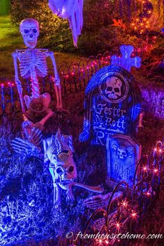 halloween decorations in the yard with skeletons and tombstones