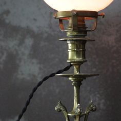 an old fashioned lamp with a white light on it