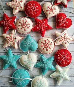 some red and white ornaments are laying on the floor together with snowflakes hanging from them