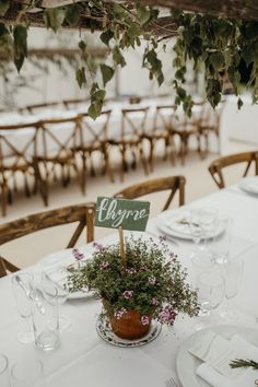 the table is set with flowers and place cards