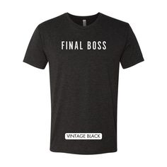 Level up your wardrobe with our "Final Boss" T-shirt, a must-have for gaming aficionados and style-savvy champions alike. Made for those who tackle life's challenges with the strategy and grit of a seasoned gamer, this tee is not just an item of clothing; it's a badge of honor. Product Features: Premium Heather fabric for a soft feel and durable wear. Bold "Final Boss" statement print, signifying your unrivaled status. Classic unisex fit that suits all body types, providing comfort and style. Id Fitted Team Name Tops For Fans, Black Slogan Fan Apparel Top, Black Slogan Top Fan Apparel, Black Slogan Top For Fan Apparel, Black Slogan Tops For Fans, Black Tops With Text Print, Fitted Team Spirit T-shirt For Game Day, Black Shirt With Text Print For Game Day, Team Spirit T-shirt With Slogan For Fans