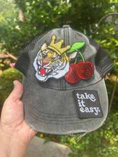 Black distressed baseball hat with snapback closure- soft and feels broken in already! Tiger with crown, cherries and "take it easy" patch. All patches will be securely fastened and ready to wear! Enjoy! Casual Outdoor Trucker Hat With Embroidered Patch, Casual Outdoor Snapback Hat With Embroidered Patch, Casual Black Trucker Hat With Embroidered Patch, Trendy Baseball Cap With Patches, Distressed Casual Trucker Hat For Outdoor, Trendy Distressed Visor Baseball Cap, Casual Outdoor Snapback Hat With Patches, Casual Distressed Trucker Hat For Outdoor, Adjustable Baseball Cap With Patches For Streetwear