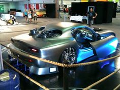 a futuristic car on display in a building