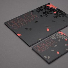 two business cards with orange and black flowers on them, one has the words beauty sleep printed on it