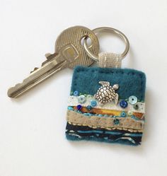 a small key chain with a turtle on it