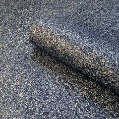 a black and white carpet with yellow dots on the top, in an area that looks like it has been made out of concrete