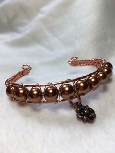 a close up of a bracelet on a white cloth