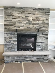 a large stone fireplace with built in shelves