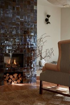 a living room with a chair and fire place