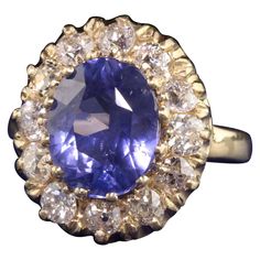 Beautiful Retro 14K Yellow Gold Ceylon Sapphire and Diamond Engagement Ring. This classic ring features a 5.12 ct No Heat color changing ceylon sapphire in the center of a halo of old european cut diamonds. This ring also comes with an AGL report stating the sapphire is natural and has no treatments done to it. Item #R0932 Metal: 14K Yellow Gold Weight: 6.3 Grams Diamond: Approximately 1.50 cts Color: H Clarity: VS2 Sapphire: 5.12 cts Ceylon No Heat / Color Change - AGL - # 1105492 Ring Size: 5 Measurements: Top measures 17.39 mm wide and band measures 2.42 mm wide. Measurement from finger to top of ring: 7.43 mm Layaway: For your convenience, we will be happy to provide layaway payment options. Please contact us to work out a layaway plan which best suits your needs. All layaway purchases Ceylon Sapphire Ring, Sapphire And Diamond Engagement Ring, Diamond Sapphire Engagement Ring, Ceylon Sapphire, Cushion Cut Diamonds, European Cut Diamonds, Art Deco Diamond, 14k White Gold Ring, Sapphire Engagement