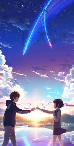 two people holding hands in front of the sky