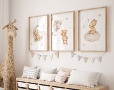 there are three pictures hanging on the wall next to a toy giraffe and other items