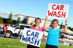 two children holding up signs that say car wash