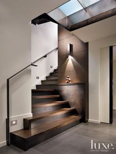 the stairs in this house are made of wood and metal, with glass on top