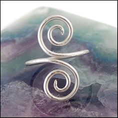 "Unusual silver finger adornment or little finger ring.  The ring is made from sterling silver wire. It has been bent into interesting swirling spirals and hammered to give a beautiful textured finish which catches the light.  This adornment is flexible and adjustable so it can be stretched or tightened accordingly. When wearing on the top of the finger I advise squeezing it slightly to ensure it securely stays put.  Each adornment is handmade to order and may vary from the one pictured.  Curren Silver Spiral Wire Wrapped Rings, Little Finger Ring, Tiny Curls, Diy Soap Recipe, Soap Recipe, Midi Rings, Diy Soap, Hand Wrap, Finger Ring